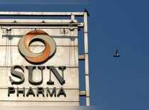 A bird flies past the logo of Sun Pharma installed on the facade of its corporate office in Mumbai