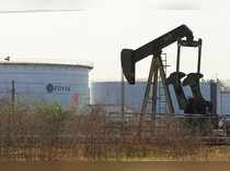 FILE PHOTO: An oil pumpjack and a tank with the corporate logo of state oil company PDVSA are seen in an oil facility in Lagunillas
