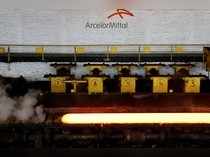 A red-hot steel plate passes through a press at the ArcelorMittal steel plant in Ghent