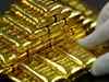 Gold hovers near 10-month peak amid steady dollar after Fed minutes