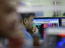 A broker reacts while trading at his computer terminal at a stock brokerage firm in Mumbai