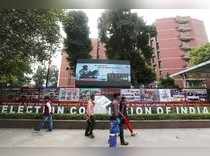 People walk past the Election Commission of India office building in New Delhi
