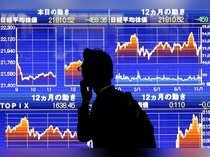 FILE PHOTO : A man looks at an electronic stock quotation board showing Japan's Nikkei average outside a brokerage in Tokyo