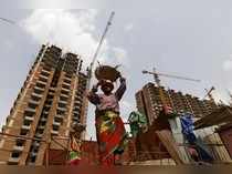 Labourers work at the construction site of a residential complex in Noida