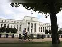 A cyclist passes the Federal Reserve building in Washington, DC