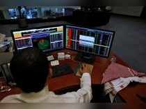 A Saudi trader observes the stock market on monitors at Falcom stock exchange agency in Riyadh