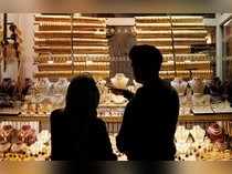 People look at gold jewelleries at a jewellery shop at the Grand Bazaar in Istanbul