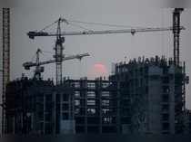 A worker walks at a construction site during dusk in Jakarta