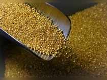 An employee takes granules of 99.99 percent pure gold at the Krastsvetmet non-ferrous metals plant in the Siberian city of Krasnoyarsk