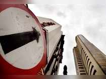 A road sign stands next to the Bombay Stock Exchange building.