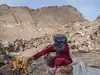 Umm Yasser prepares tea for hikers