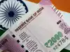 Rupee falls below 70-mark against dollar amid weakness across EM currencies