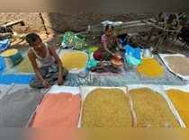 New Delhi: A shop-keeper attends a customer at the wholesale market for pulses a...