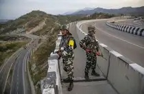 Jammu: Security personnel stand guard on Jammu-Srinagar National Highway as the ...