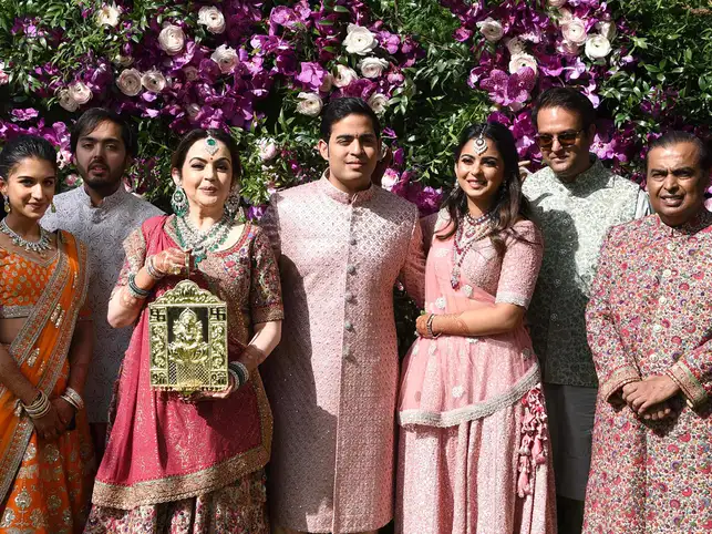 The Ambanis with Anand Piramal (2R) and Radhika Merchant (L) at Akash's wedding.