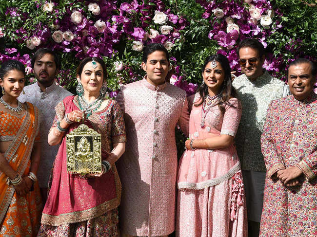 ​The Ambanis with Anand Piramal (2R) and Radhika Merchant (L) at Akash's wedding.