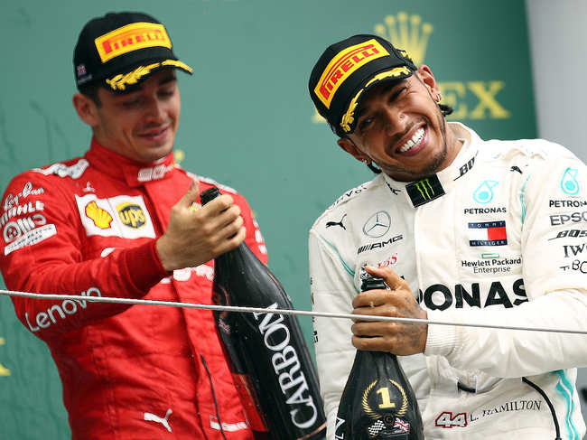 NORTHAMPTON, ENGLAND - JULY 14: Race winner Lewis Hamilton of Great Britain and Mercedes GP celebrates on the podium with third placed Charles Leclerc of Monaco and Ferrari during the F1 Grand Prix of Great Britain at Silverstone on July 14, 2019 in Northampton, England. (Photo by Bryn Lennon/Getty Images)