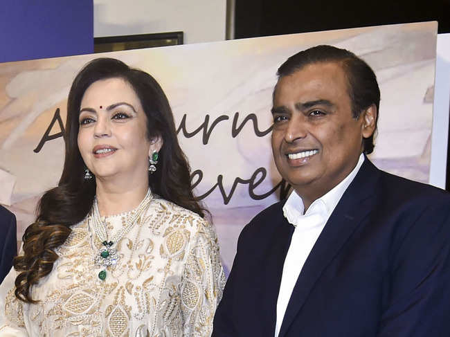 ​Nita Ambani opted for an ivory-gold ensemble, and Mukesh Ambani looked sharp in a tailored suit.