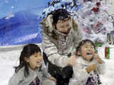 Family plays with artificial snow powder