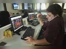 Mumbai: Stock broker react as they watch the stock prices on a computer screen, ...