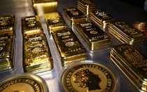 FILE PHOTO: Gold bars and coins at the Pro Aurum gold house in Munich