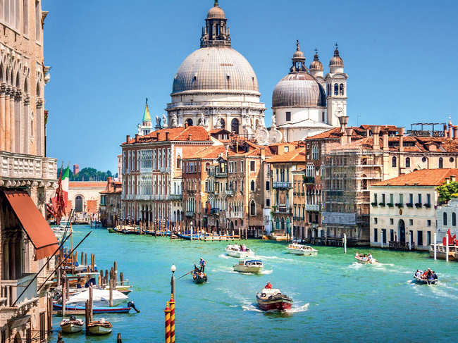COUPLE GONDOLA RIDES: Beautiful views of the famous Canal Grande with Basilica di Santa Maria della Salute in the background on a sunny day in Venice, Italy is a big hit with Indian couples on a romantic trip to Italy.
