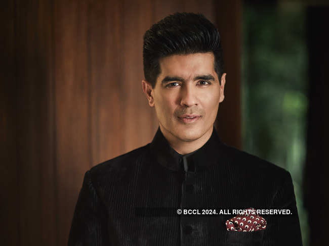 Manish Malhotra likes to add 'a little bit of drama' to his outfits with a scarf.