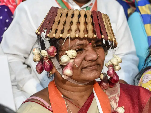 A supporter of National Congress party wearing onions as necklace and hat ornaments attends a 'Janvedna Yatra' (rally) against the price rise of onions and vegetables in Ahmedabad.