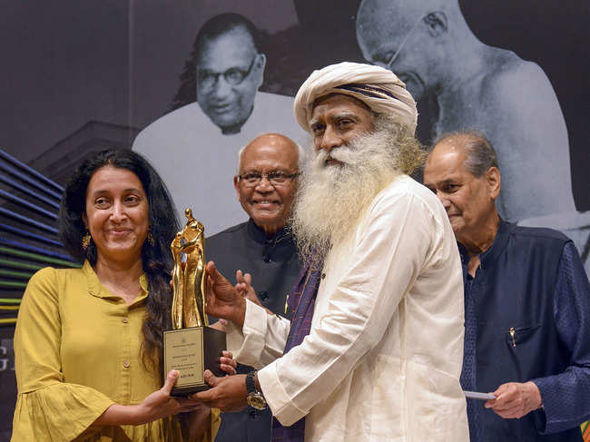 ?Sadhguru Jaggi Vasudev (2nd R) along with notes scientist RA Mashelkar (2nd L) and Rahul Bajaj (R) presents 42nd Jamnalal Bajaj Award 2019 to Shaheen Mistri (L), at the award function in Mumbai.?