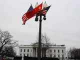 A Chinese national flag in between two US flags