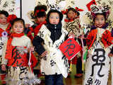 Chinese children posing with calligraphy