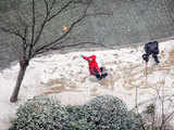 Children play with snow in downtown Shanghai