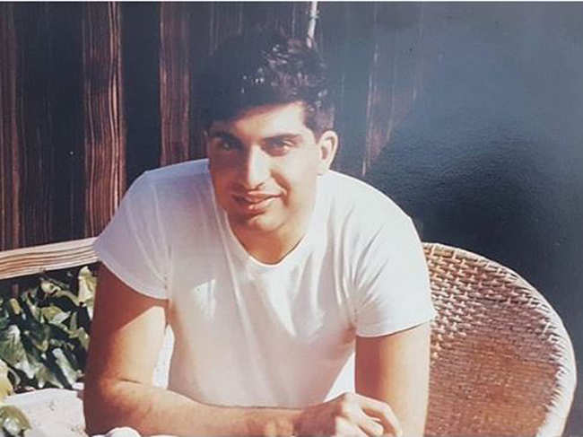 The photo shows a young Ratan Tata, clad in a white shirt, looking at the camera.