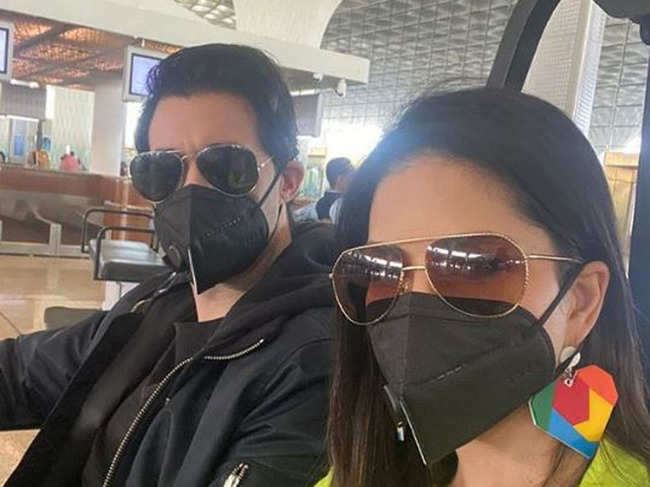 In the photograph, Sunny can be seen with her husband Daniel Weber, both donning a black-coloured mask.