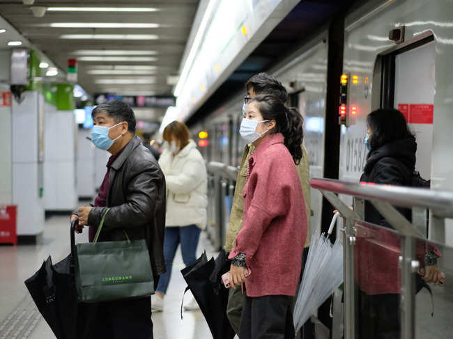 People wearing surgical mask walking out from subway in Shanghai.
