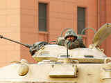 An Egyptian soldier rests in his tank inside Tahrir Square in Cairo