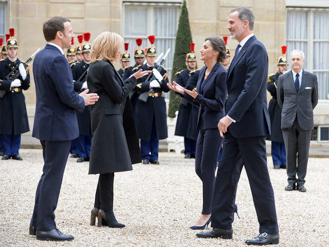 Macron models virus-proof greeting