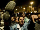 An Egyptian anti-government demonstrator waves a shoe