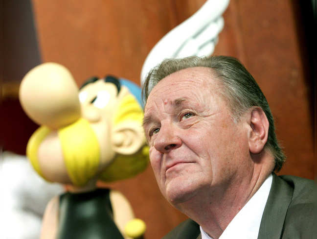 Albert Uderzo, the artist of all thirty-three Asterix adventures and story writer of the last nine books, sits next to a model of Asterix during a news conference in Brussels.