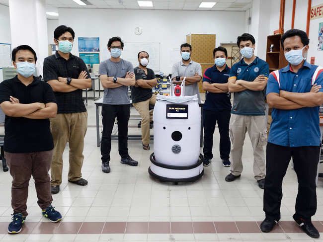Engineering professors pose with the version two prototype of the IIUM Medibot medical robot at the International Islamic University Malaysia in Gombak, on the outskirts of Kuala Lumpur.