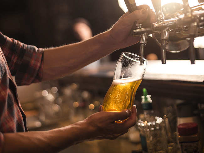 Brown fills pint glasses for his customers out of taps on the side of the van.