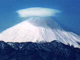 Lenticularis caps the snow covered Mount Fuji