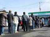 People queue outside a market in Sendai