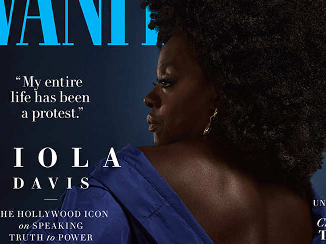 On the cover, Davis is wearing a blue gown with a deep plunge in the back, hand on hip.