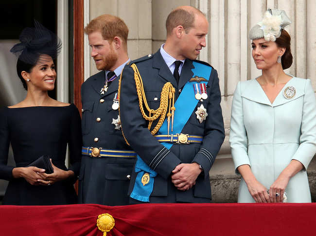 (L-R) ​Meghan Markle, Pricne Harry, Prince William and Kate Middleton on the balcony of Buckingham Palace as they watch a fly past to mark the centenary of the Royal Air Force in central London in 2018.