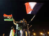 Libyans wave the national flag and the French tricolor