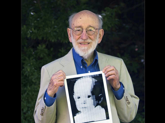 File photo of 2007, Russell Kirsch holds the image of his son, Walden, that was scanned into the world's first digital scanner in 1957.