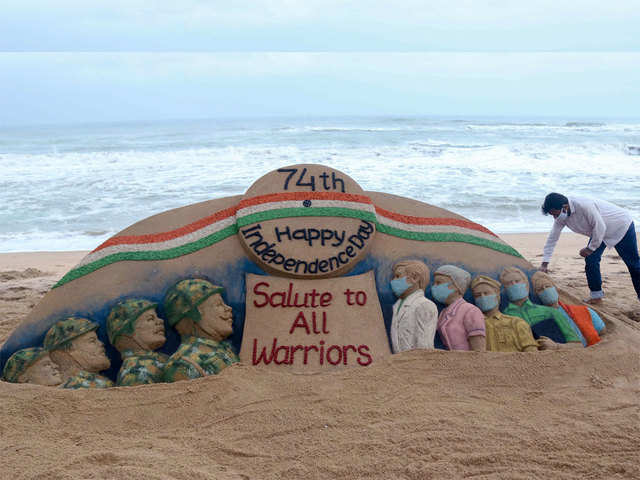 Sand artist Sudarsan Pattnaik creates a sand sculpture with message 'Salute to All Warriors' on the eve of 74th Independence Day