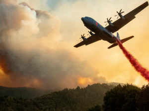An aircraft drops fire retardant on a ridge during the Walbridge fire, part of the larger LNU Lightning Complex fire as flames continue to spread in Healdsburg, California AFP