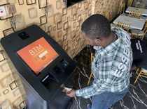 A bitcoin user buys bitcoins with naira on Bitcoin Teller Machine in Lagos